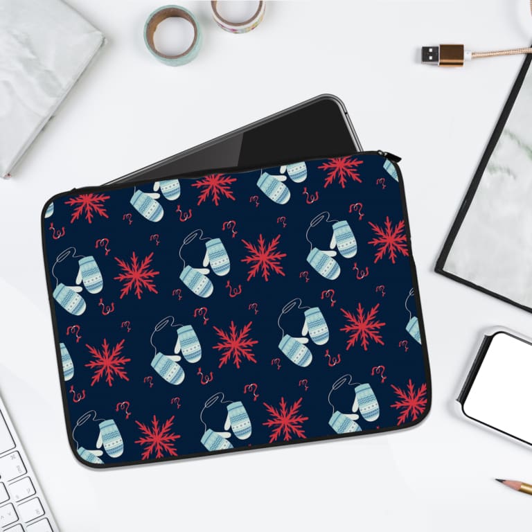 Dark blue laptop sleeve with white and red star patterns. laptop sleeve kept on a plain white background