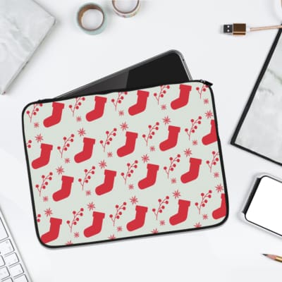 Infidu Christmas laptop sleeve with red stockings and holly berries on a white background, adding a festive touch for the holidays. laptop sleeve kept on a plain white background