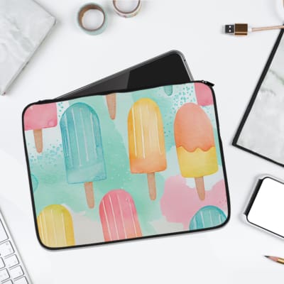 Laptop sleeve with light blue background and pastel popsicle pattern in pink, yellow, blue, and purple, featuring a zip closure. laptop sleeve kept on a plain white background