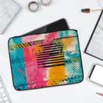 Infidu Colorful Abstract Laptop Sleeve featuring bright pink, blue, yellow, and black colors with stripes and dots on a vibrant design. laptop sleeve kept on a plain white background