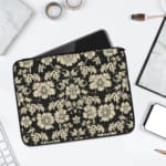 Infidu Black & Gold Floral Laptop Sleeve with a black background and detailed white floral pattern, featuring a secure zip closure. laptop sleeve kept on a plain white background