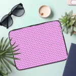 Light purple laptop sleeve with white triangle pattern, designed for a modern and minimalist look. the laptop sleeve on the table