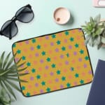 Infidu Green and Pink Star Pattern Laptop Sleeve with small green and pink stars on a light green background, displayed on a desk. the laptop sleeve on the table the laptop sleeve on the table