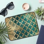 Infidu Rustic Beige Floral Blue Teal Laptop Sleeve with floral pattern in blue and teal tones on a faded beige background. the laptop sleeve on the table