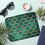 Infidu Teal Wave Pattern Laptop Sleeve with modern wave design on a vibrant teal background. the laptop sleeve on the table