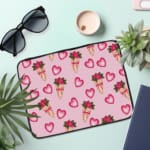 Infidu Romantic Heart & Floral Print Laptop Sleeve with pink hearts and flower bouquets on a white background. the laptop sleeve on the table