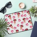 Infidu Romantic Heart & Floral Print Laptop Sleeve with pink hearts and flower bouquets on a white background. the laptop sleeve on the table