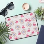 Infidu Cute Pink Heart Print Laptop Sleeve with Blue heart pattern on white background, perfect for stylish laptop protection. the laptop sleeve on the table