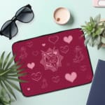 Infidu Romantic Dark Pink Heart Design Laptop Sleeve with intricate heart patterns and a couple of illustrations. the laptop sleeve on the table