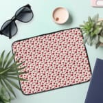 Infidu White Laptop Sleeve with Red Heart Pattern, featuring small red hearts on a white background for a playful look. the laptop sleeve on the table