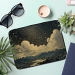 Infidu Night Sky Clouds Stars Laptop Sleeve with dark background, stars, and clouds design. the laptop sleeve on the table