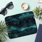 Infidu Night Sky Cosmic Cloud Stars Laptop Sleeve with dark cosmic design, featuring clouds, stars, and waves; protective fabric laptop sleeve with zip closure the laptop sleeve on the table