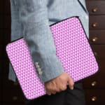 Light purple laptop sleeve with white triangle pattern, designed for a modern and minimalist look. the person holding the sleeve