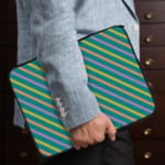 Infidu Colorful Striped Diagonal Lines Laptop Sleeve in green, blue, yellow, and pink. the person holding the sleeve