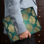 Infidu Elegant Dark Teal Floral Laptop Sleeve with beige and silver floral pattern on a dark teal background. the person holding the sleeve