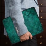 Infidu dark green laptop sleeve with textured pattern design the person holding the sleeve