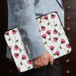 Infidu Floral Pink & Green Laptop Sleeve with pink flowers and green stems on a white background, offering protection and style. the person holding the sleeve