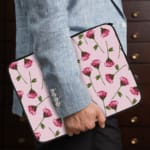 Floral Pink Flower Design Laptop Sleeve with white background, featuring pink flowers and green stems for a fresh look. the person holding the sleeve