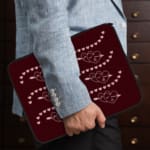 Infidu Maroon Laptop Sleeve with Heart & Wave Pattern design, featuring hearts and dotted wave lines in light colors against a maroon background. the person holding the sleeve