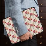 Infidu Heart-Shaped Balloon Pattern Laptop Sleeve with pink and red heart balloons, strings, and leaf details. the person holding the sleeve