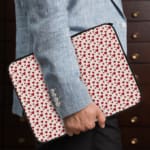 Infidu White Laptop Sleeve with Red Heart Pattern, featuring small red hearts on a white background for a playful look. the person holding the sleeve