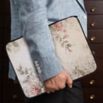 Infidu Soft Floral Pink & Beige Elegant Laptop Sleeve with delicate flowers in light pink, beige, and cream shades. the person holding the sleeve