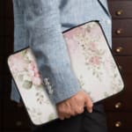 Infidu Soft Floral Pink & Beige Elegant Laptop Sleeve with delicate flowers in light pink, beige, and cream shades. the person holding the sleeve