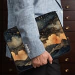 Infidu Night Sky Clouds Stars Laptop Sleeve with dark background, stars, and clouds design. the person holding the sleeve