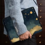 Infidu Night Sky Laptop Sleeve with Stars, Moon, and Clouds design on a dark blue background, offering a dreamy celestial theme for laptop protection. the person holding the sleeve