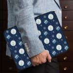 Infidu Dark Blue Winter Snowflake & Gift Laptop Sleeve with festive snowflakes, gifts, and a holiday design. the person holding the sleeve