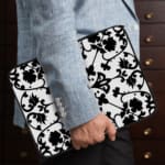 Infidu black and white mandala art laptop sleeve with intricate floral design. the person holding the sleeve