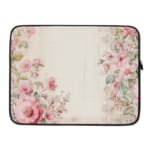 Soft beige laptop sleeve with delicate floral design in pink, green, and purple, featuring a zip closure for secure storage. laptop sleeve kept on a plain white background