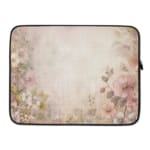 Soft beige laptop sleeve with delicate floral design in pink, green, and purple, featuring a zip closure for secure storage. laptop sleeve kept on a plain white background