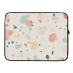 Pastel terrazzo-style laptop sleeve with pink, yellow, blue, and gray shapes on a light background, laptop sleeve kept on a plain white background