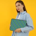 Infidu Colorful Striped Diagonal Lines Laptop Sleeve in green, blue, yellow, and pink. the person holding the sleeve