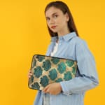 Infidu Vintage Floral Laptop Sleeve in blue, teal, and beige, with a classic floral pattern designed for laptop protection and style. the person holding the sleeve