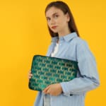 Infidu Teal Wave Pattern Laptop Sleeve with modern wave design on a vibrant teal background. the person holding the sleeve