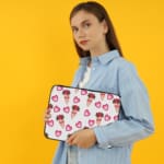 Infidu Romantic Heart & Floral Print Laptop Sleeve with pink hearts and flower bouquets on a white background. the person holding the sleeve