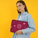 Infidu Romantic Dark Pink Heart Design Laptop Sleeve with intricate heart patterns and a couple of illustrations. the person holding the sleeve