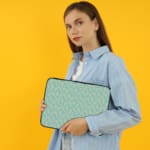 Infidu Simple Light Blue Pattern Laptop Sleeve with subtle design on a light background, featuring zip closure for easy access and protection. the person holding the sleeve