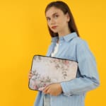 Infidu Soft Floral Pink & Beige Elegant Laptop Sleeve with delicate flowers in light pink, beige, and cream shades. the person holding the sleeve