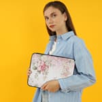 Infidu Soft Floral Pink & Beige Elegant Laptop Sleeve with delicate flowers in light pink, beige, and cream shades. the person holding the sleeve