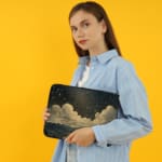 Infidu Night Sky Clouds Stars Laptop Sleeve with dark background, stars, and clouds design. the person holding the sleeve