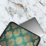 Infidu Elegant Dark Teal Floral Laptop Sleeve with beige and silver floral pattern on a dark teal background. The laptop sleeve covers the laptop