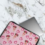 Infidu Romantic Heart & Floral Print Laptop Sleeve with pink hearts and flower bouquets on a white background. The laptop sleeve covers the laptop