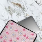 Infidu Light Pink Laptop Sleeve with Mug & Heart Print Design featuring small mugs with blue hearts and pink heart prints. The laptop sleeve covers the laptop