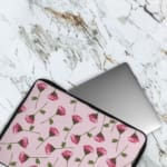 Floral Pink Flower Design Laptop Sleeve with white background, featuring pink flowers and green stems for a fresh look. The laptop sleeve covers the laptop