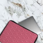 Infidu pink floral textured laptop sleeve with a delicate pattern and secure zip. The laptop sleeve covers the laptop