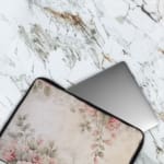 Infidu Soft Floral Pink & Beige Elegant Laptop Sleeve with delicate flowers in light pink, beige, and cream shades. The laptop sleeve covers the laptop