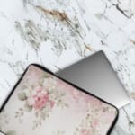 Infidu Soft Floral Pink & Beige Elegant Laptop Sleeve with delicate flowers in light pink, beige, and cream shades. The laptop sleeve covers the laptop